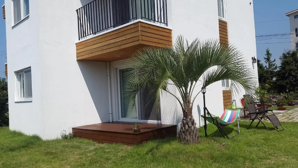 Garden-facing deck beneath a wooden balcony